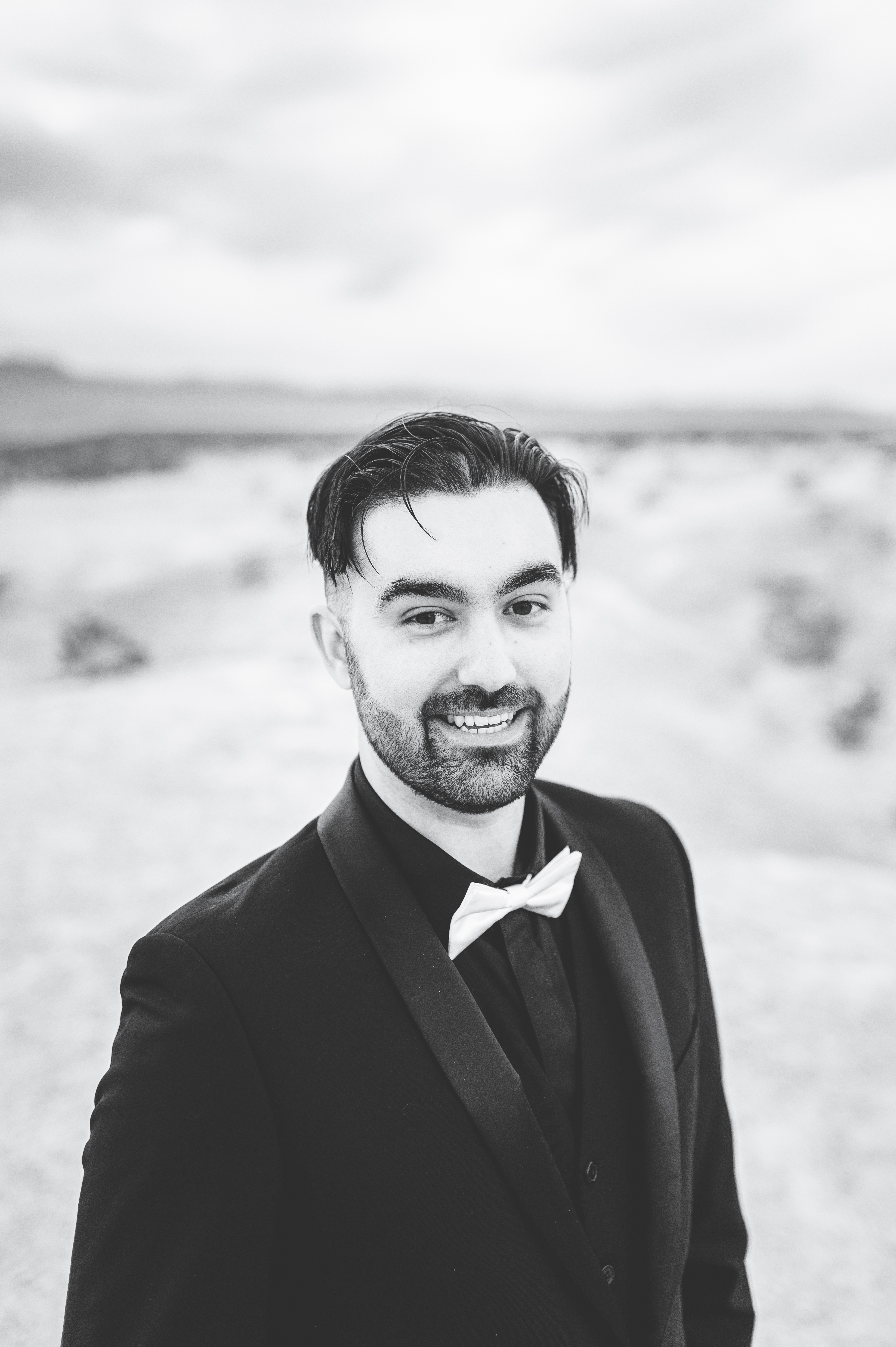 Nish in a black tuxedo outside